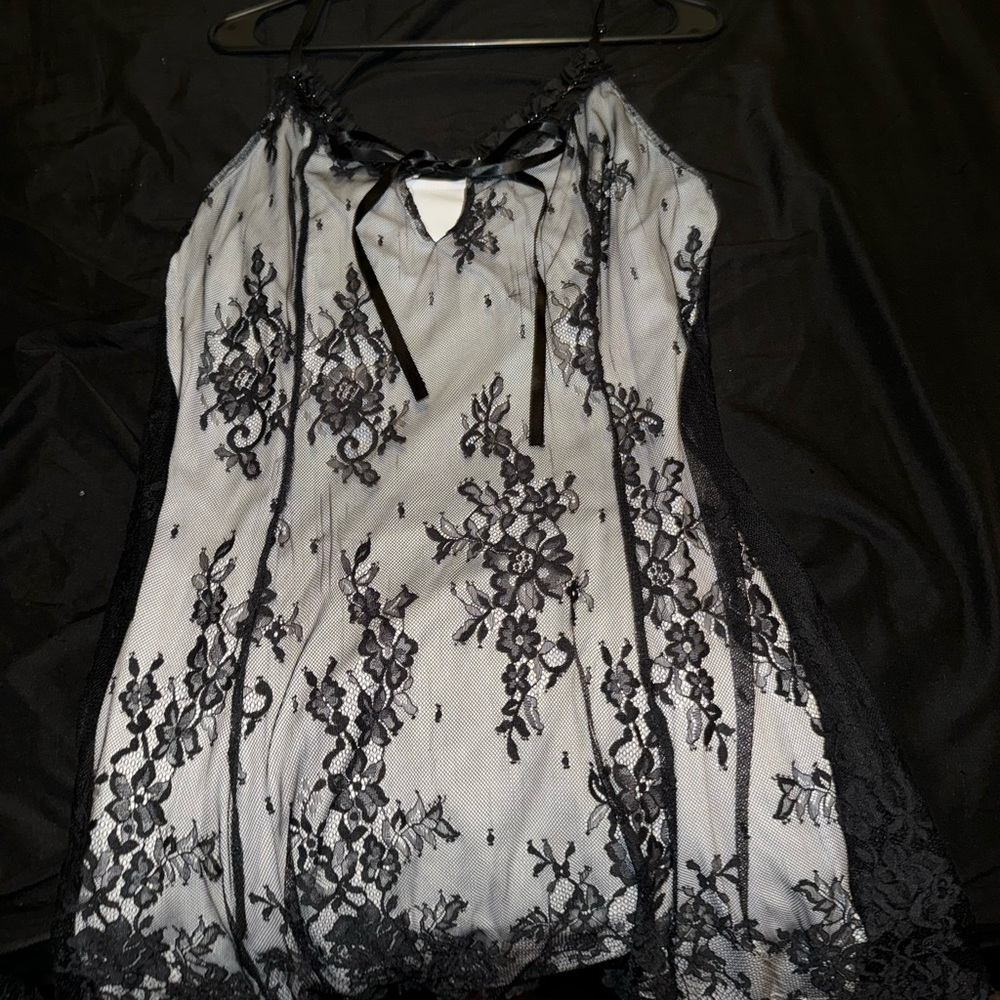 White dress with black lace over it